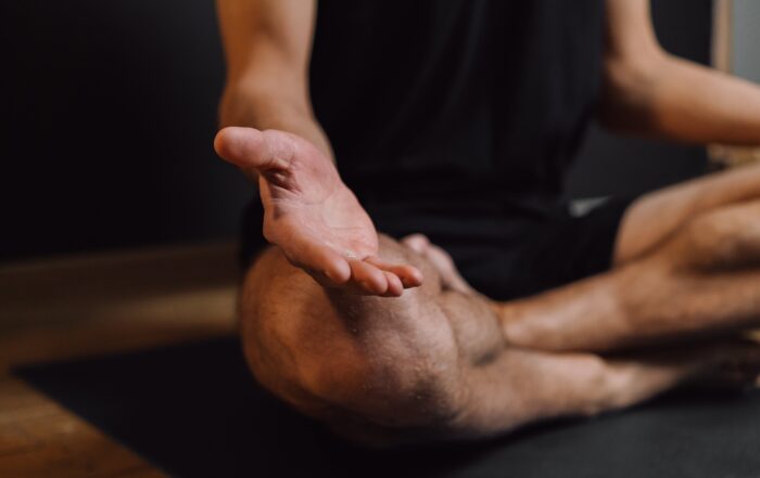 man sitting in lotus yoga pose